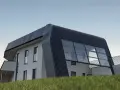 Moderna casa autosuficiente con techo curvo y grandes ventanales, rodeada de hierba alta bajo un cielo despejado.