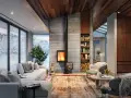 Chimenea moderna de leña, un ejemplo de los tipos de chimenea que calientan este acogedor salón con vistas nevadas.